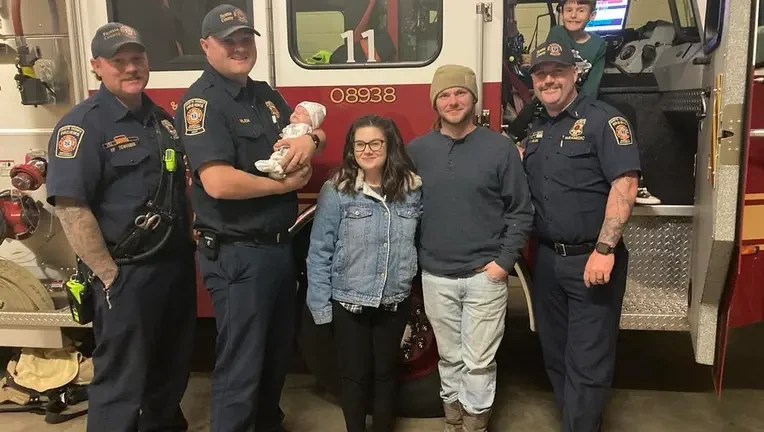Fayette County Fire fighters holding a baby